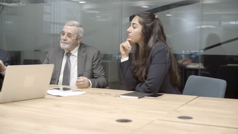 Concentrated-business-team-communicating-in-conference-room